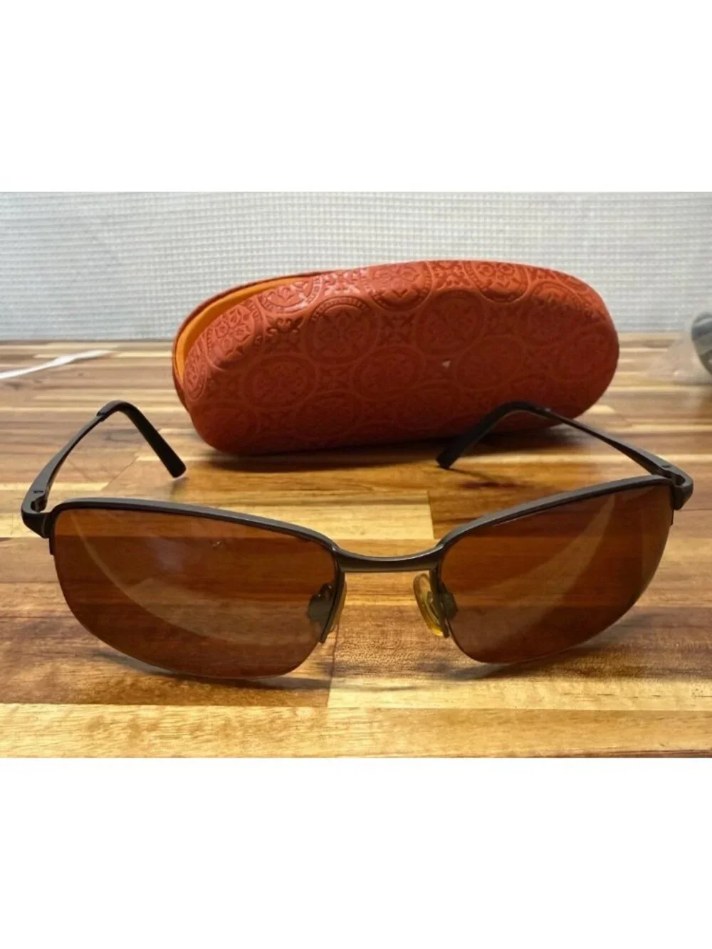 Nice pair of sunglasses with hard embossed case, cleaning cloth
